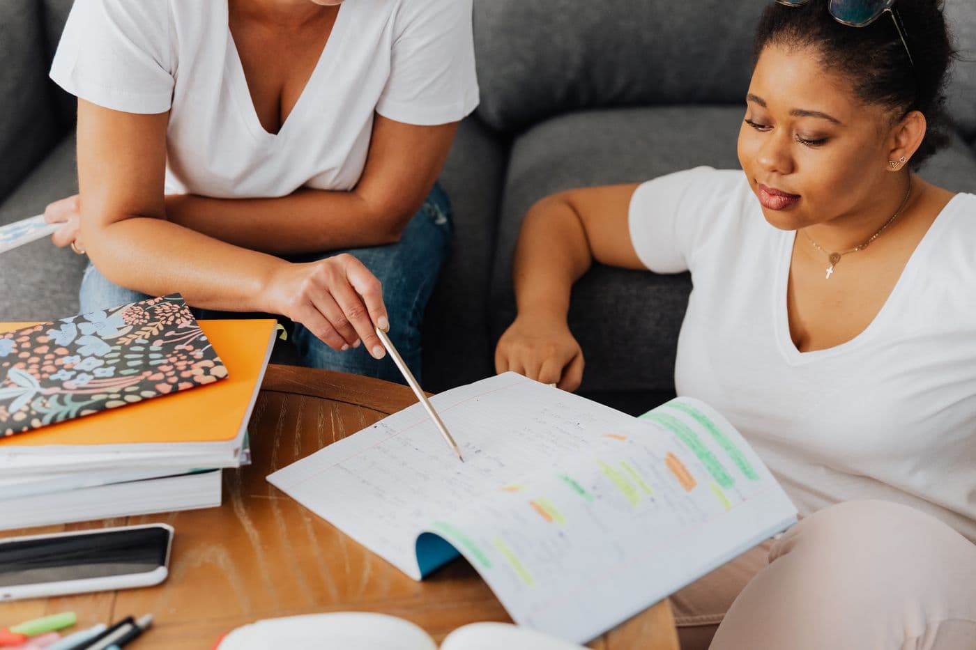 Tutor guiding a student through a workbook